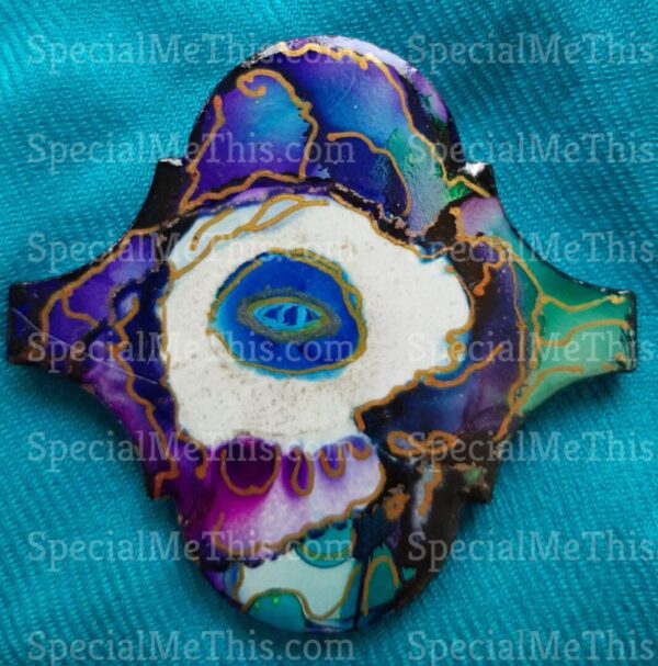 A purple and blue Arabesque Magnets with an eye on it.
