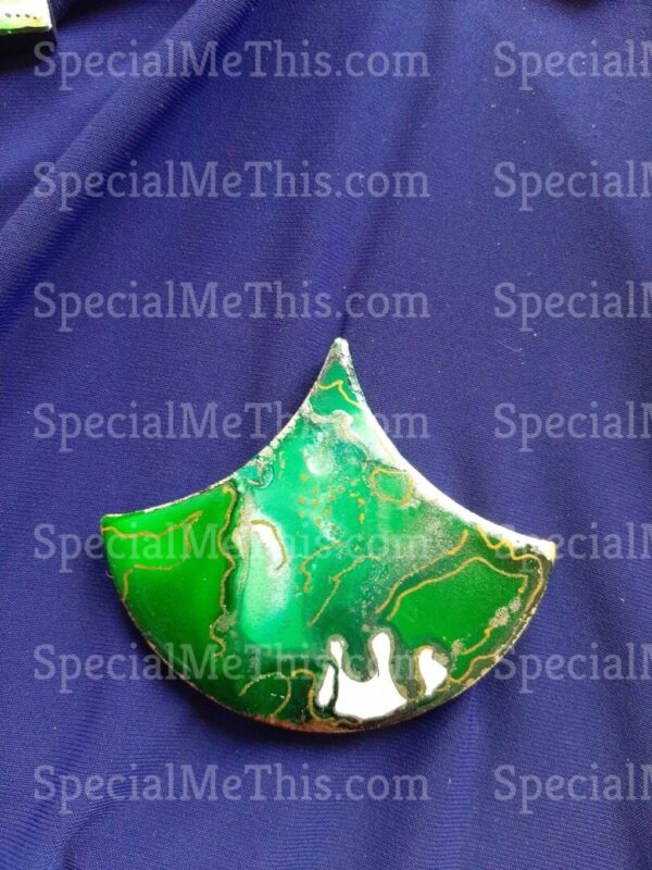 A green jade pendant on a blue cloth.
