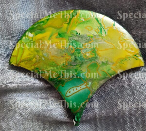 A fan with green and yellow paint on it.