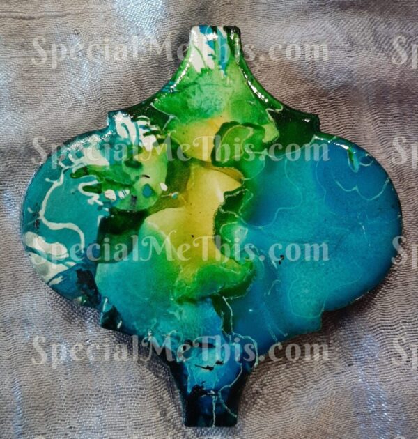 A green, blue, and yellow glass pendant.