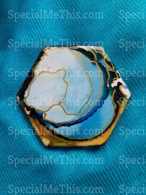 A blue and yellow geode on top of a blue cloth.