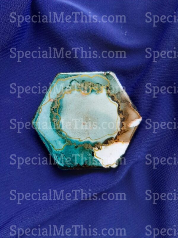 A hexagonal piece of turquoise on a blue background.