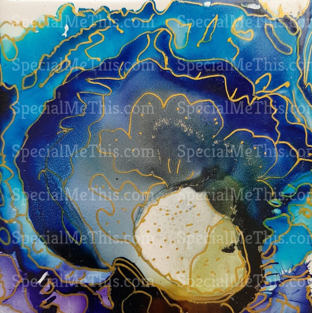 A blue and gold Across the Universe -1 painting on a tile.