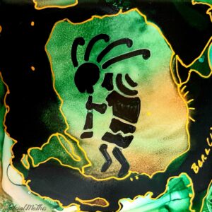 A Kokopelli with Horn in Green plate with an image of an ape on it.