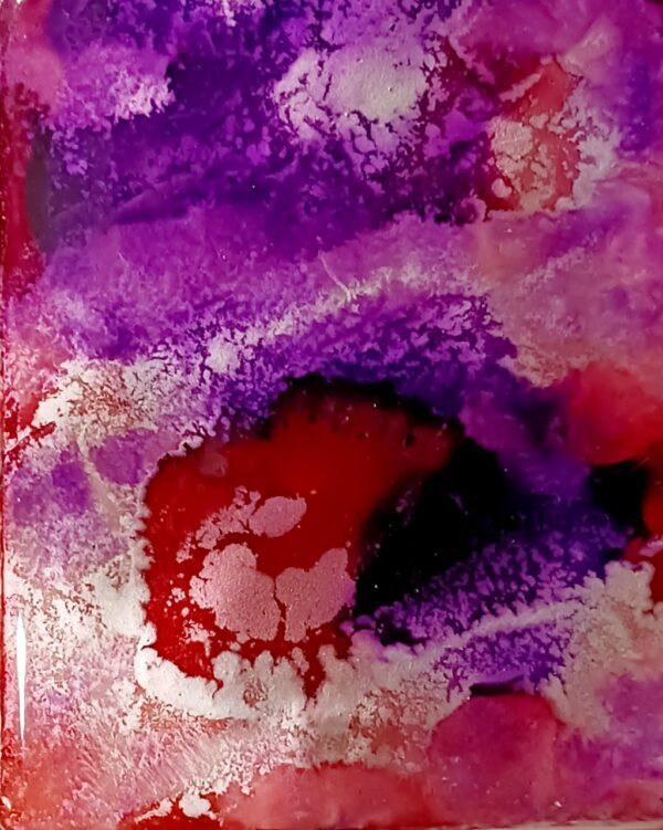 A close up of the purple and red colors in this painting.