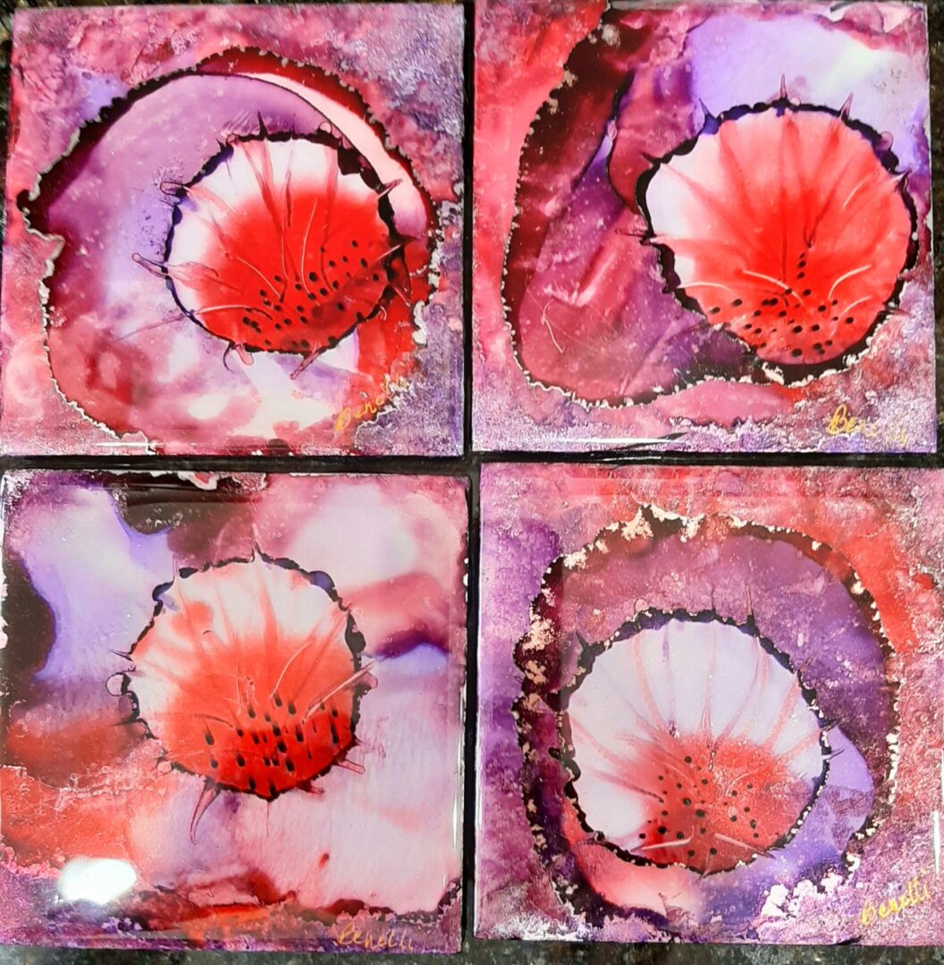 A set of Burst of Spring Coasters, with red and purple flowers on them, perfect for use as coasters.